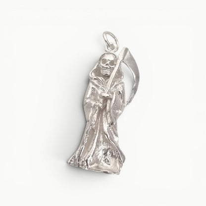 Sterling silver grim reaper pendant featuring a detailed sculpted figure in a flowing robe holding a scythe, Symbol of mortality. 