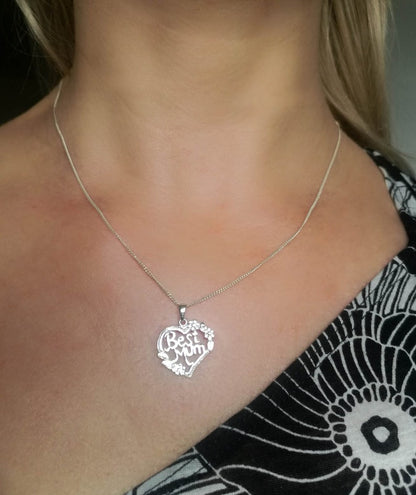 Sterling silver Best Mum heart shape pendant with flowers worn by model. 