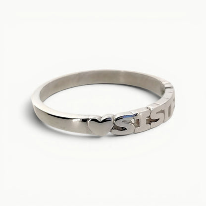 Side view of sterling silver sister band ring with hearts