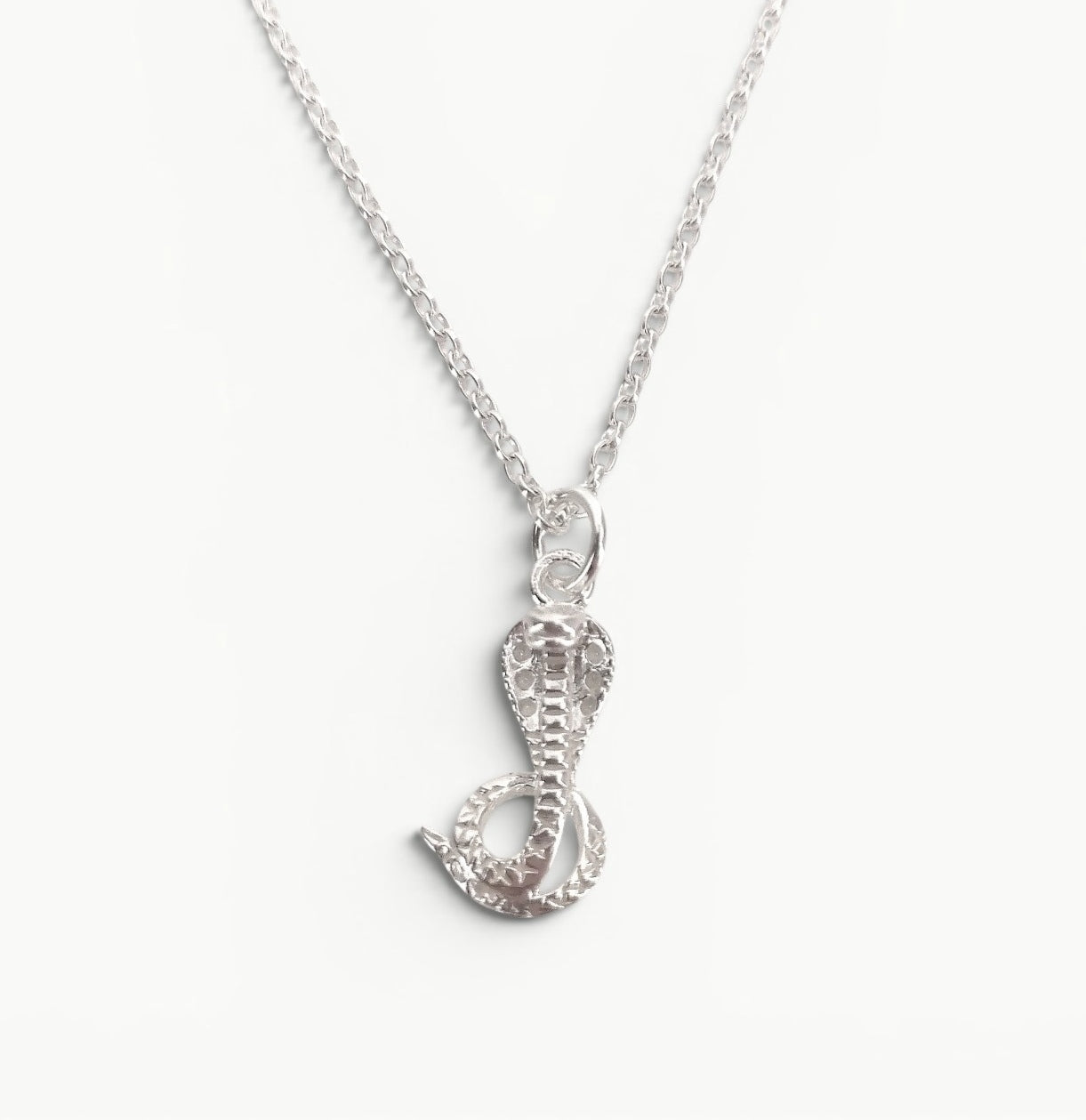 Sterling silver cobra pendant on a 20" belcher chain 