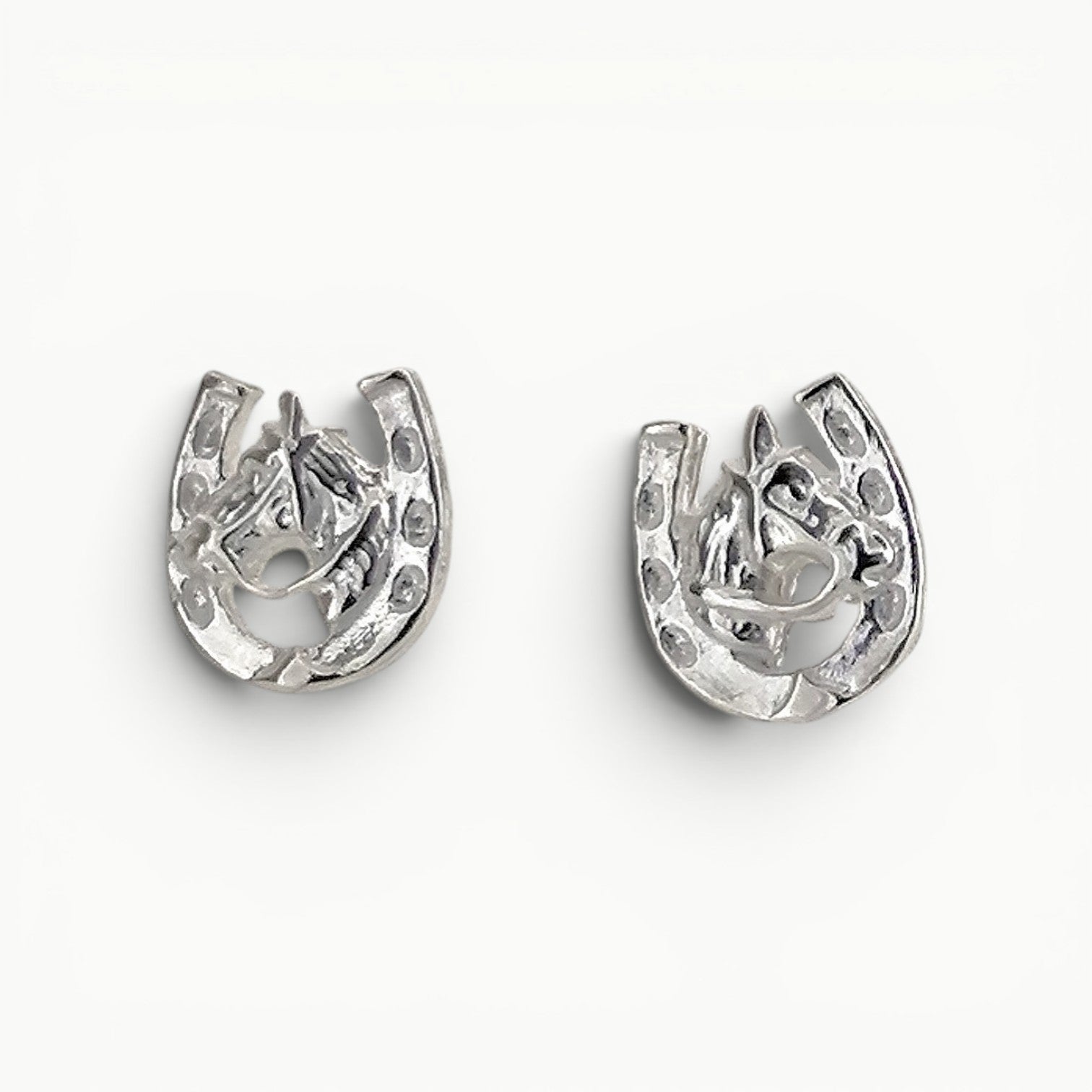 Sterling Silver horseshoe with horse head stud earrings. 