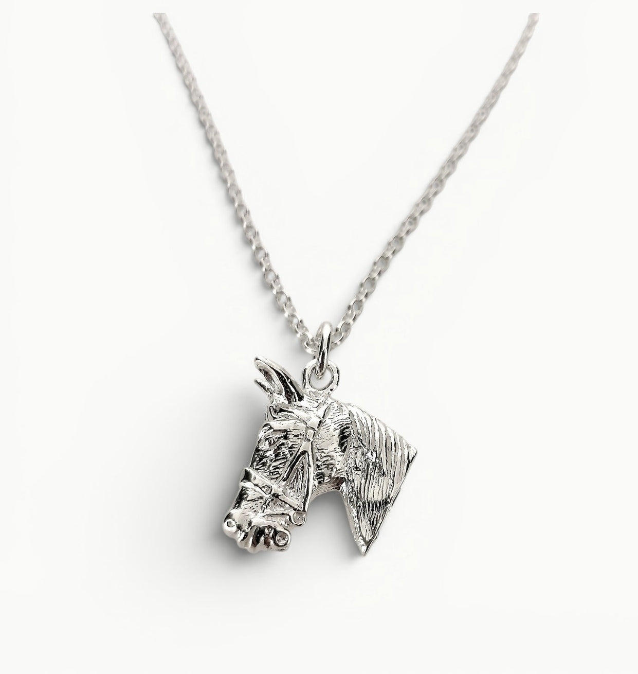 Sterling silver horse head charm pendant on a 22" belcher link chain. 