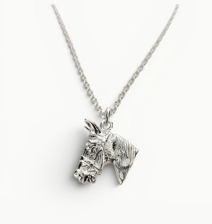 Sterling silver horse head charm pendant on a 22" belcher link chain. 