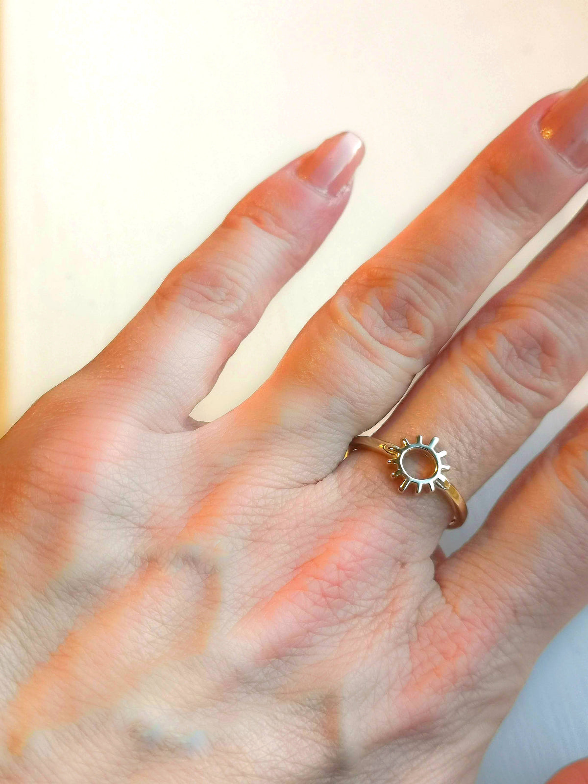 9ct yellow gold sun ring worn on ladies hand