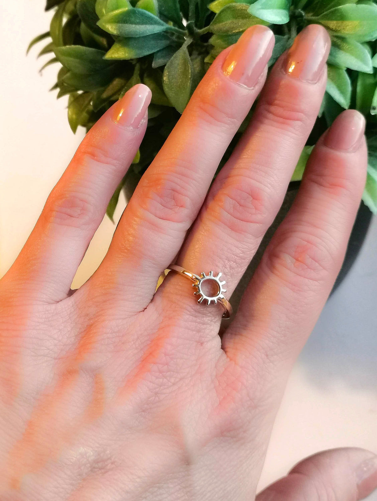 9ct yellow gold sun rays ring worn on ladies hand
