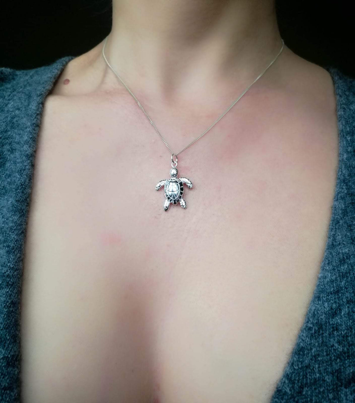 Solid Sterling Silver Sea Turtle Pendant Necklace worn on a female model.