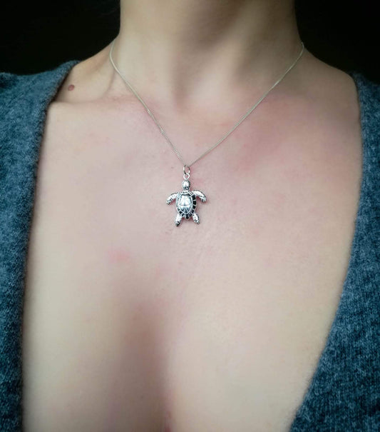 Solid Sterling Silver Sea Turtle Pendant Necklace worn on a female model.